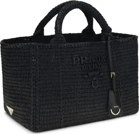 Black woven handbag with Prada logo on a white background