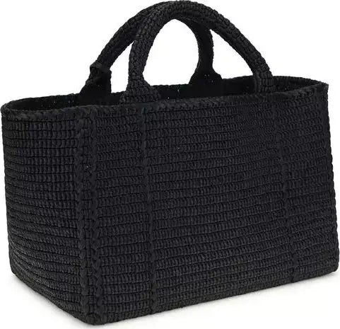 Black woven handbag on a white background