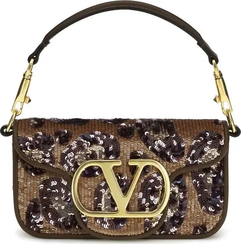 Designer handbag with sequin detailing and gold logo on a white background