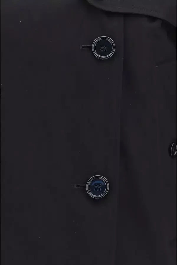 Close-up of a black coat with buttons on a dark background
