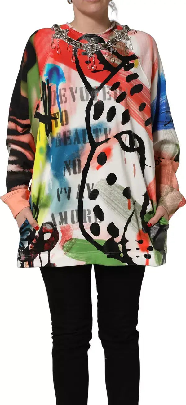 Colorful abstract patterned top worn by a person on a white background