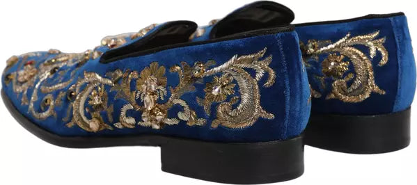 Blue velvet shoes with gold embroidery on a white background