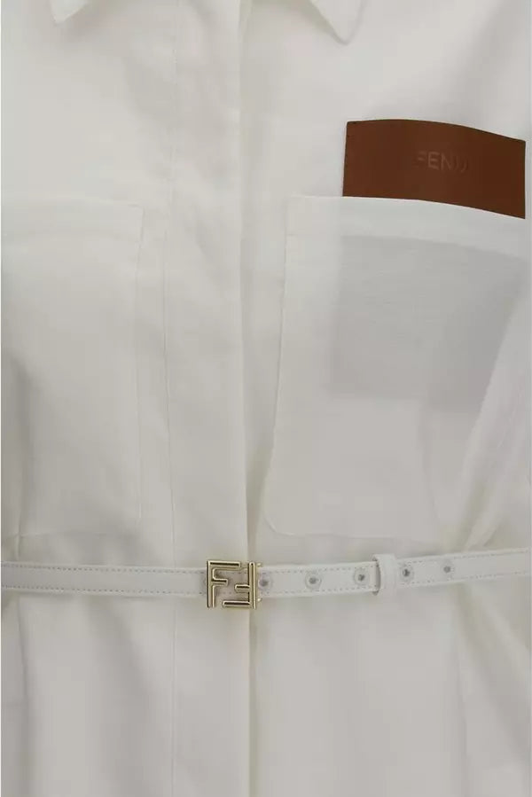 Close-up of a white coat with a brown patch and gold zipper detail.