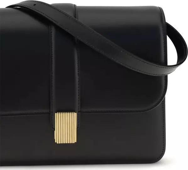 Black leather handbag with a gold clasp on a white background