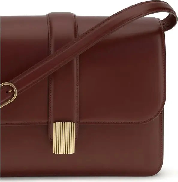 Brown leather handbag with a gold clasp on a white background
