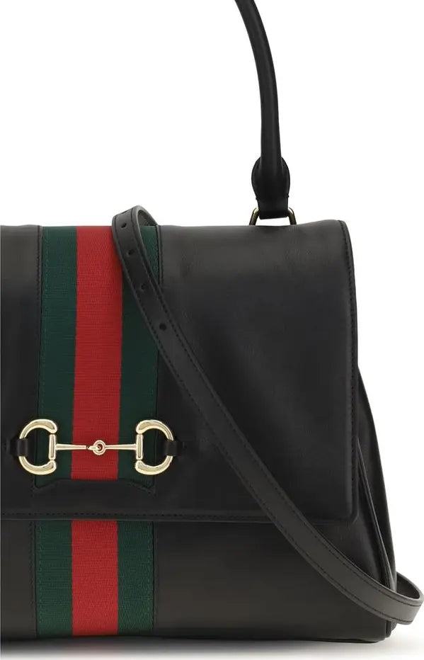 Black handbag with red and green stripes and gold horsebit detail on a white background