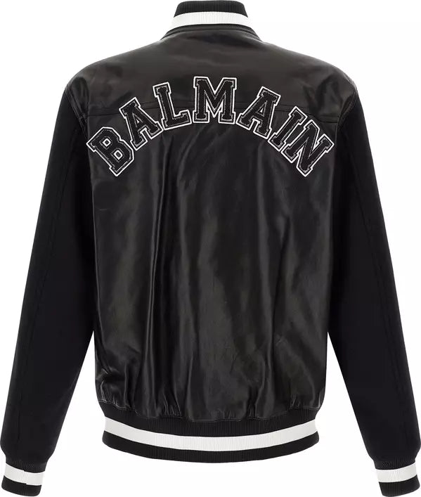 Black Balmain satin bomber jacket shown from the back, featuring &