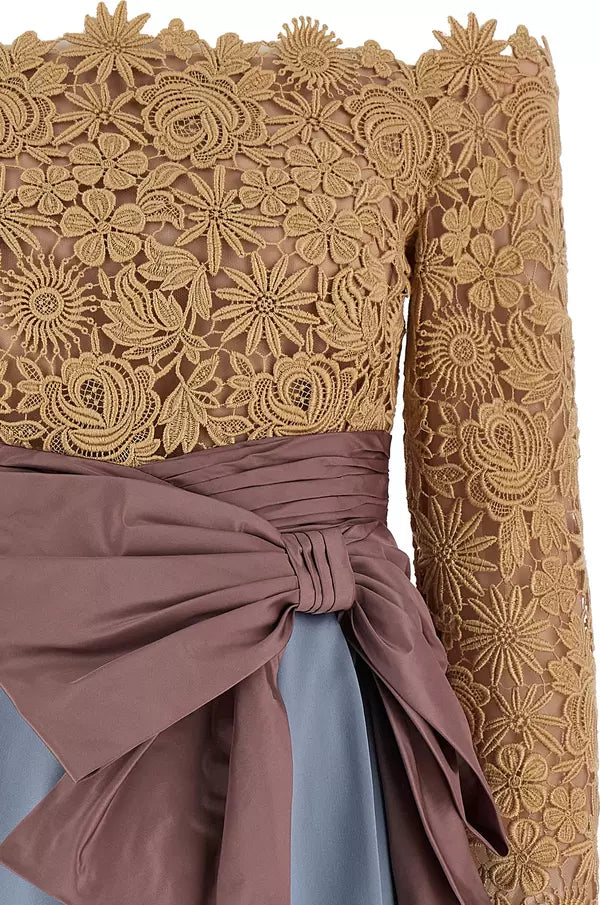 Close-up of a dress with gold lace top and brown fabric skirt.