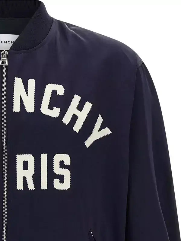 Navy bomber jacket with 'NCHY RIS' text on a white background