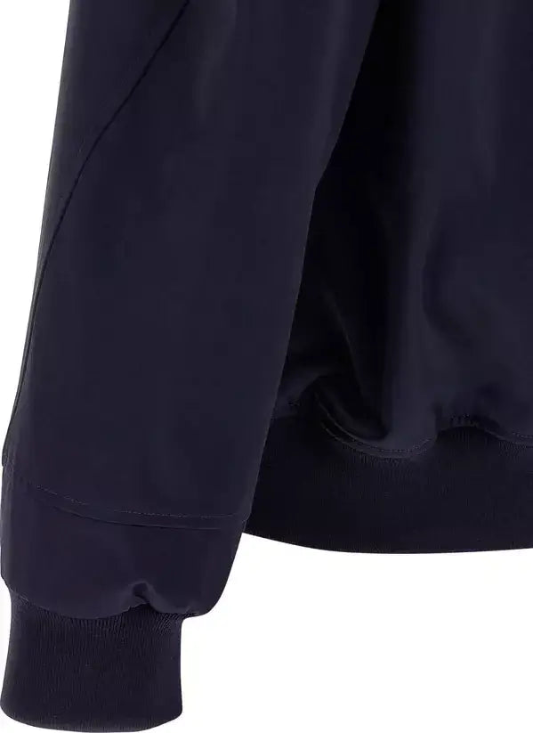 Navy blue jacket with a focus on the sleeve and waistband on a white background