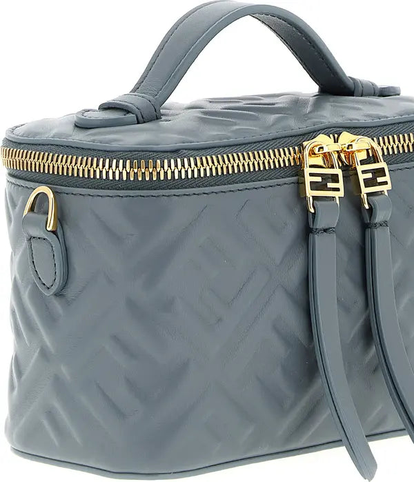 Gray quilted handbag with gold zipper and accents on a white background