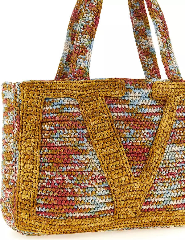 Multicolored woven handbag with a handle on a white background