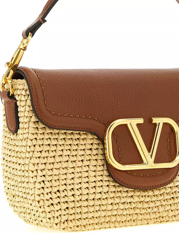 Brown leather and straw handbag with gold logo clasp on a white background