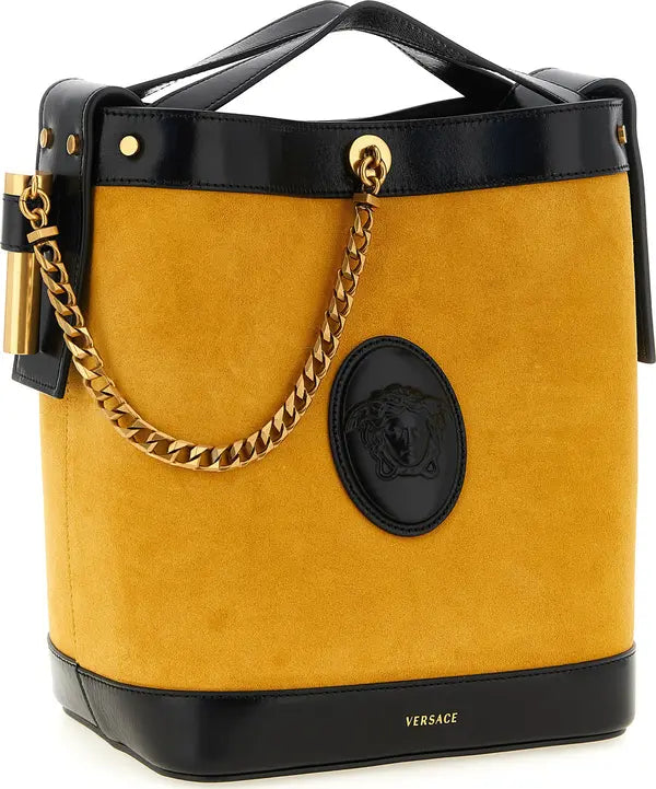 Versace handbag with gold chain and black handle on a white background