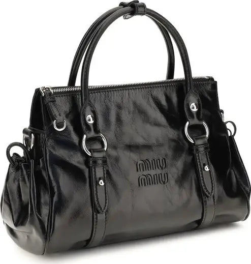 A black faux-leather handbag with double top handles, silver-tone hardware, and embossed &