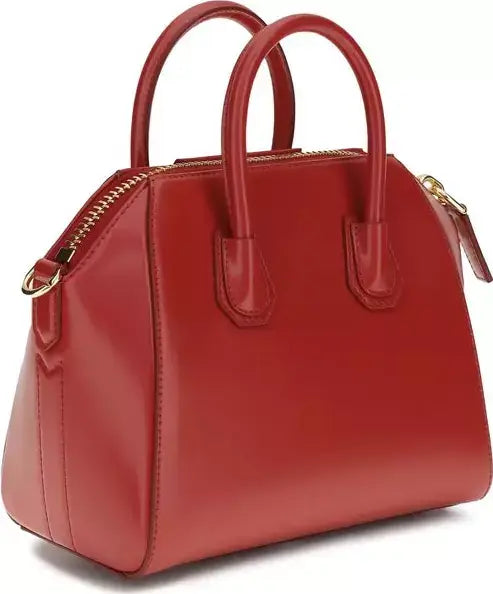 A structured red leather handbag with double top handles, a gold-tone zipper, and gold hardware, shown on a clean white background.