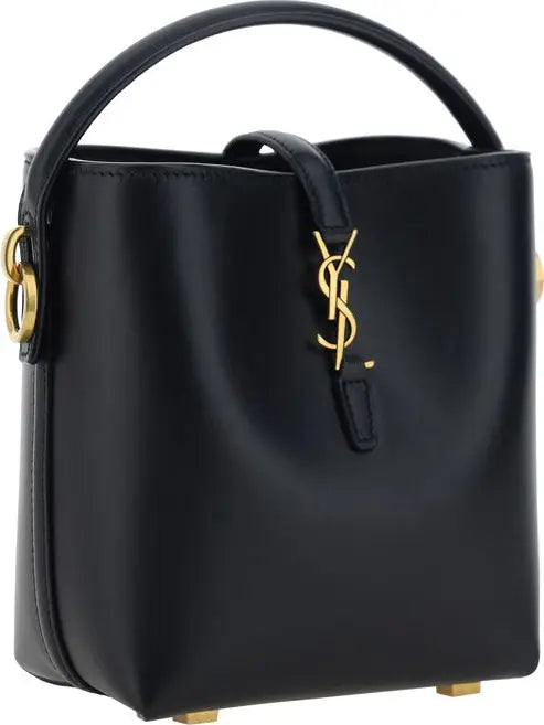 A black leather Saint Laurent bucket bag with gold-tone hardware, featuring the iconic YSL logo on the front and a top handle, set against a plain white background.