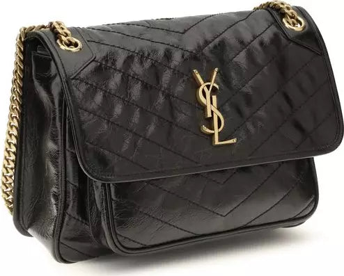 A black quilted leather shoulder bag with a gold-tone YSL monogram logo on the front flap and a gold chain strap, shown on a white background.