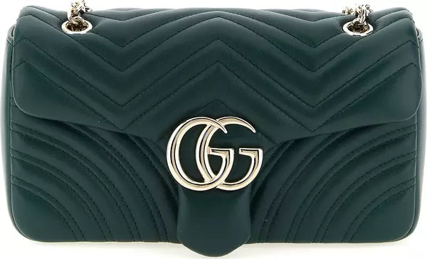 A dark green quilted leather shoulder bag with a prominent silver-tone interlocking GG logo on the front, set against a plain white background.
