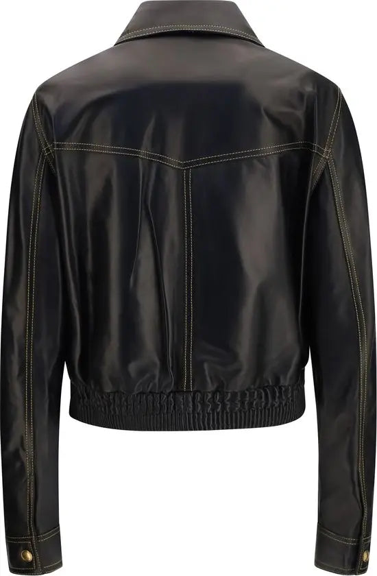 Black faux leather cropped jacket shown from the back, featuring contrast light-colored stitching and gold-tone snap buttons on the cuffs.