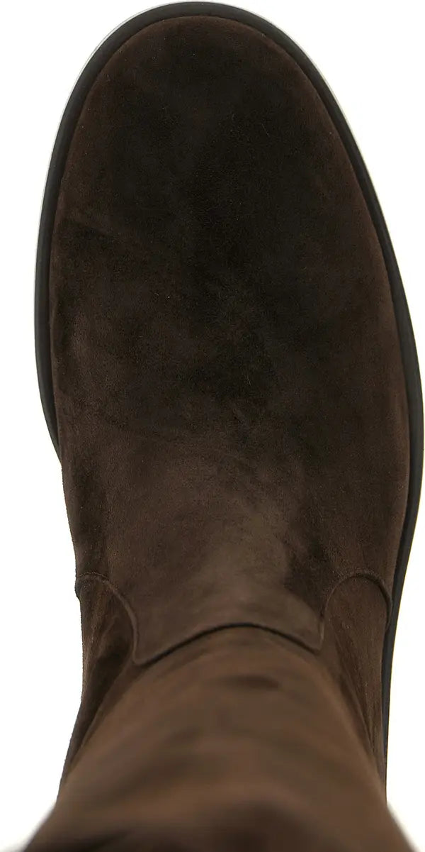 A close-up top-down view of a dark brown suede boot against a plain white background.