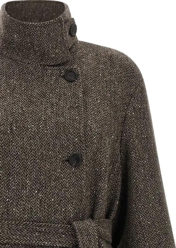Close-up of a textured herringbone tweed coat in dark brown and gray, featuring a high mock neck collar and black buttons.
