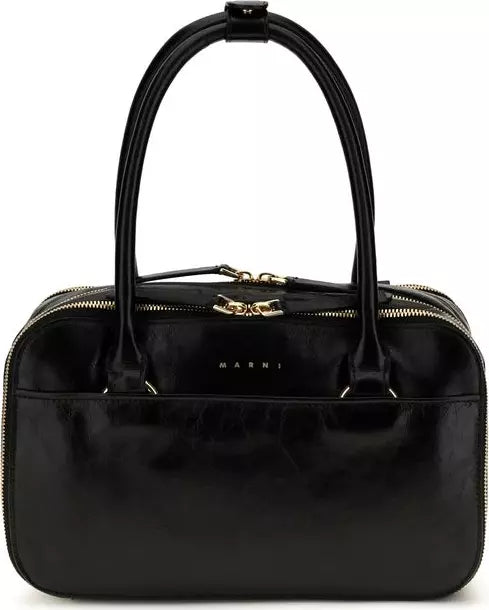A black patent leather handbag by Marni, featuring a structured dome shape, dual top handles, gold-tone zippers, and a gold-tone chain detail on the front.
