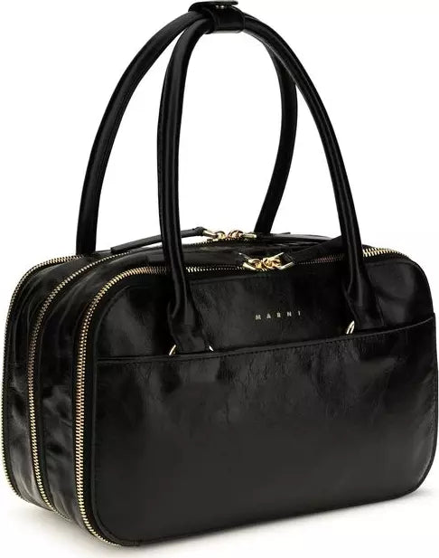 A black leather Marni handbag with double top handles, gold-tone zippers, and a gold-tone logo clasp on a white background.