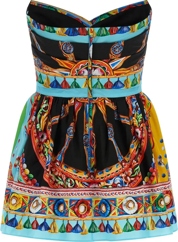 A strapless mini dress featuring a vibrant multicolor baroque and mandala print over a black base, with a light blue waistband and a decorative border along the hem.