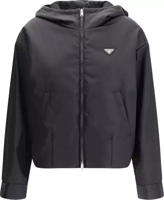 A black hooded zip-up jacket with a small silver-tone Prada triangle logo on the left chest, displayed against a solid white background.