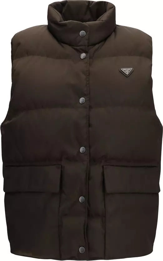 A dark brown puffer vest with a high collar, snap-button front, and a small triangular Prada logo on the left chest, shown against a plain white background.
