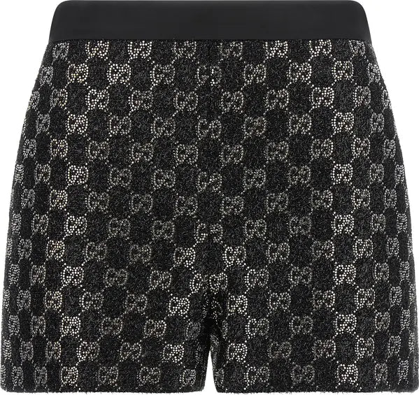 Black and silver Gucci shorts featuring an all-over GG monogram pattern made of sparkling rhinestones, with a solid black waistband.