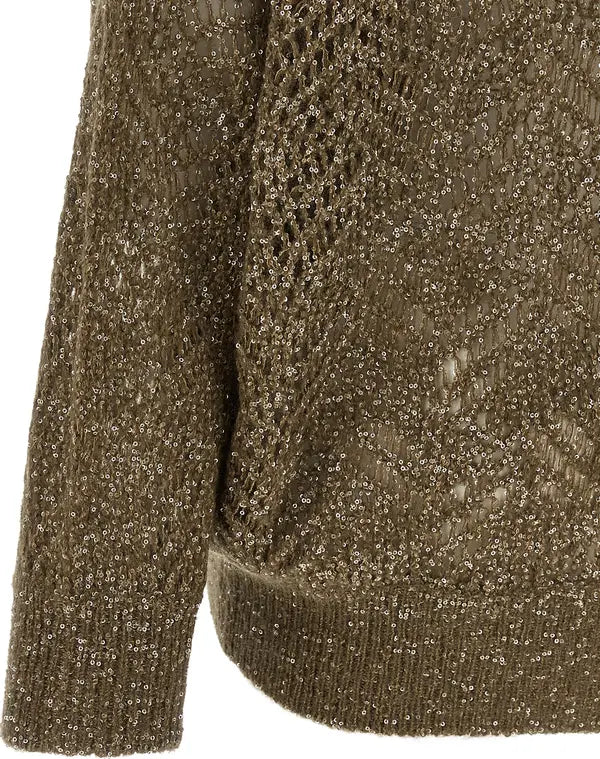 Close-up of a textured knit sweater with a shimmering metallic bronze finish, showing the ribbed sleeve cuff and hem against a white background.