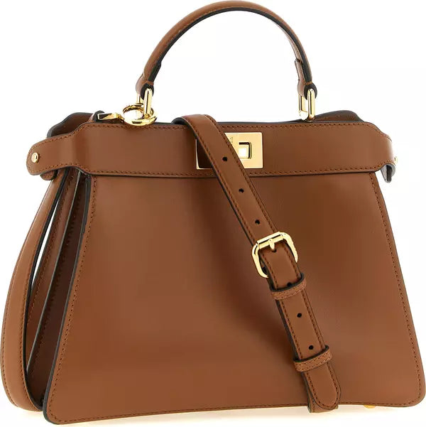 A structured brown leather handbag with a top handle, a detachable shoulder strap, and gold-tone hardware, shown on a plain white background.