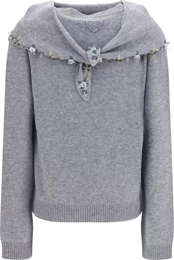 A light gray knit sweater with a wide collar decorated with small white flowers and silver beads, featuring a tie closure at the center chest.