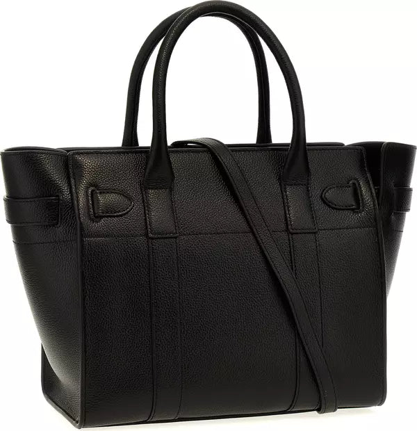 A black pebbled leather tote bag with dual top handles and a detachable shoulder strap, shown against a plain white background.