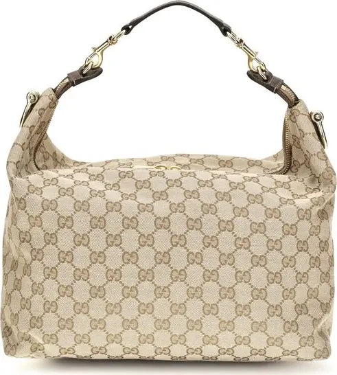 A Gucci shoulder bag in beige GG Supreme canvas with brown leather trim and gold-tone hardware, shown against a plain white background.