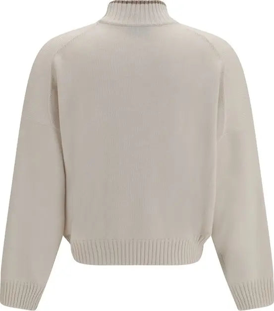 A cropped knit sweater with a mock neck, shown from the back. The sweater is a light cream or off-white color, which maps to Beige under the schema&