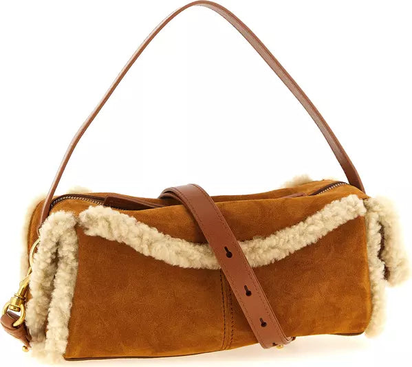 A brown suede shoulder bag with a thick cream shearling lining and a matching brown leather strap, shown against a plain white background.