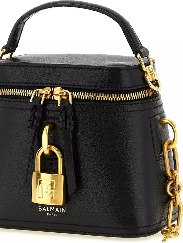 Black Balmain leather top-handle handbag with gold-tone hardware, including a padlock closure, zipper, and chain strap, shown on a white background.