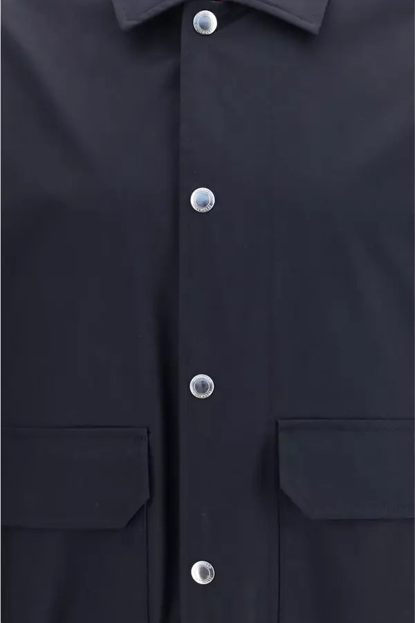 Close-up of a dark navy button-up shirt with silver buttons and two front flap pockets.