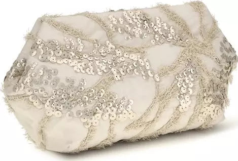 A small, irregularly shaped clutch bag covered in shimmering silver sequins and metallic embroidered leaf patterns on a light beige fabric background, set against a plain white background.