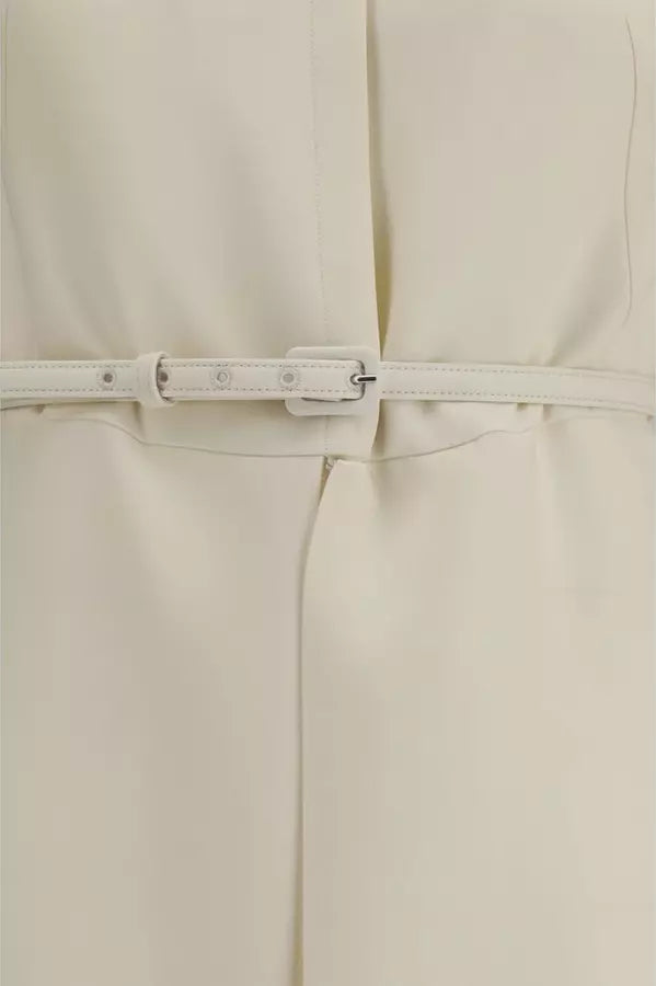 Close-up of a cream-colored garment with a matching thin belt and silver-tone buckle.