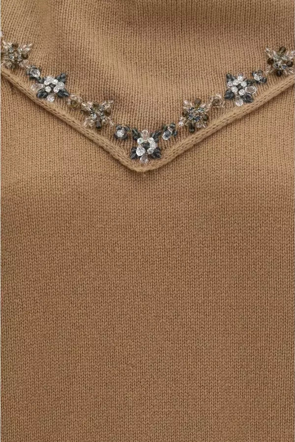 Close-up of a camel brown knit sweater featuring a V-neckline embellished with silver and clear rhinestone floral details.