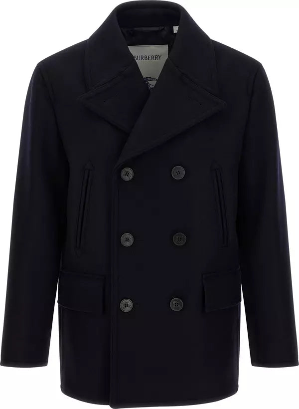A dark navy blue double-breasted coat with a wide collar and dark buttons, shown against a plain white background. The brand label &