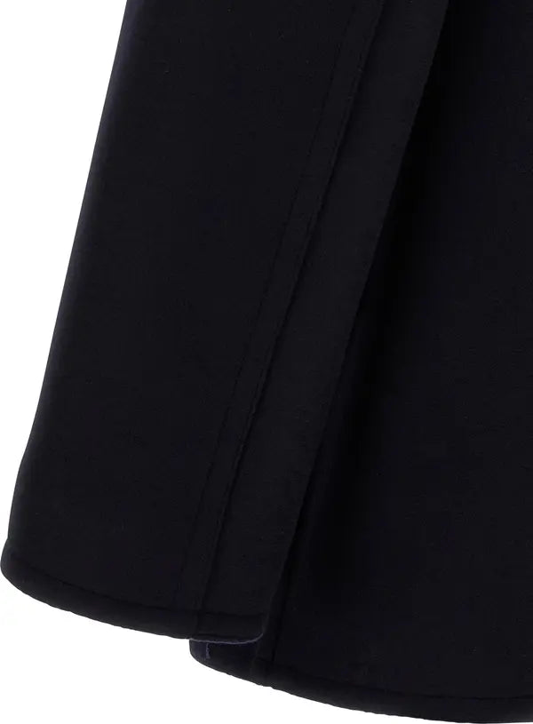Close-up detail of a black garment, showing a folded cuff or hem with clean stitching against a white background.
