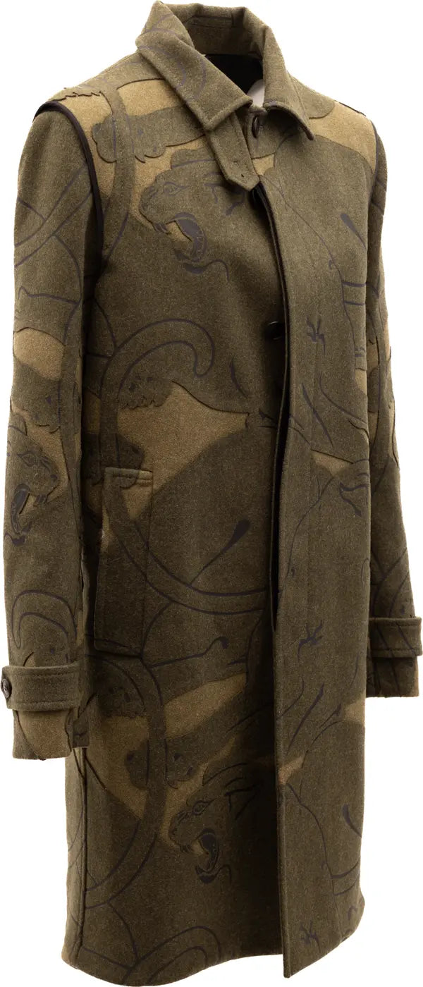 A long olive green wool coat with a dark brown abstract pattern, featuring a pointed collar and front button closure, shown on a plain white background.