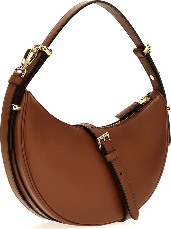 A brown leather crescent-shaped shoulder bag with gold-tone hardware, a top handle, and a front strap detail, shown on a plain white background.