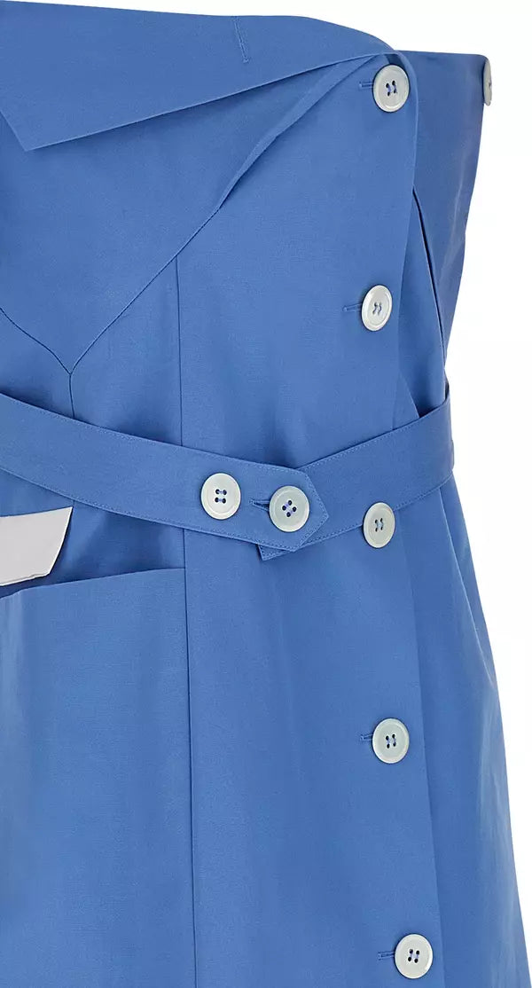 Close-up of a blue structured garment with a matching belt, decorative buttons, and a white pocket detail on a white background.