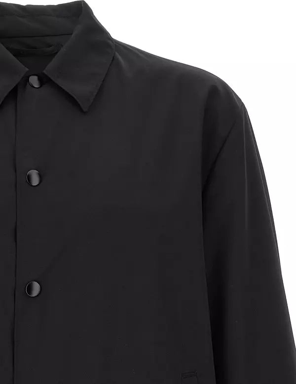 Close-up of a black long-sleeve collared shirt jacket with dark buttons, shown against a plain white background.